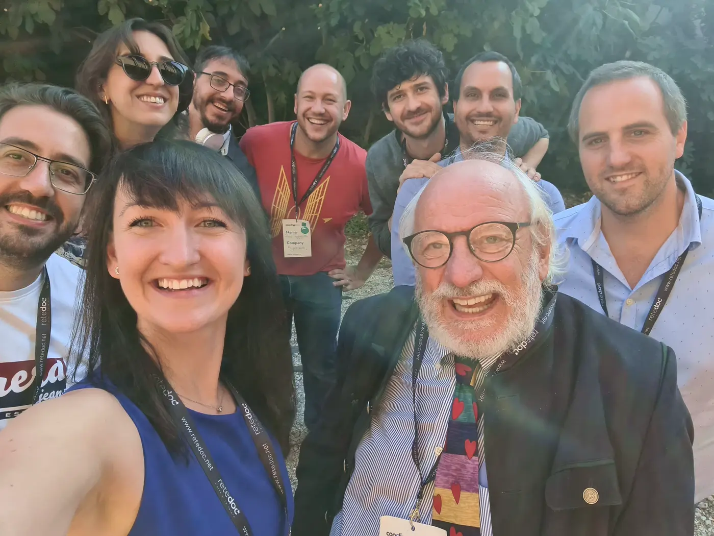 Patio members taking a group selfie outdoors at a conference